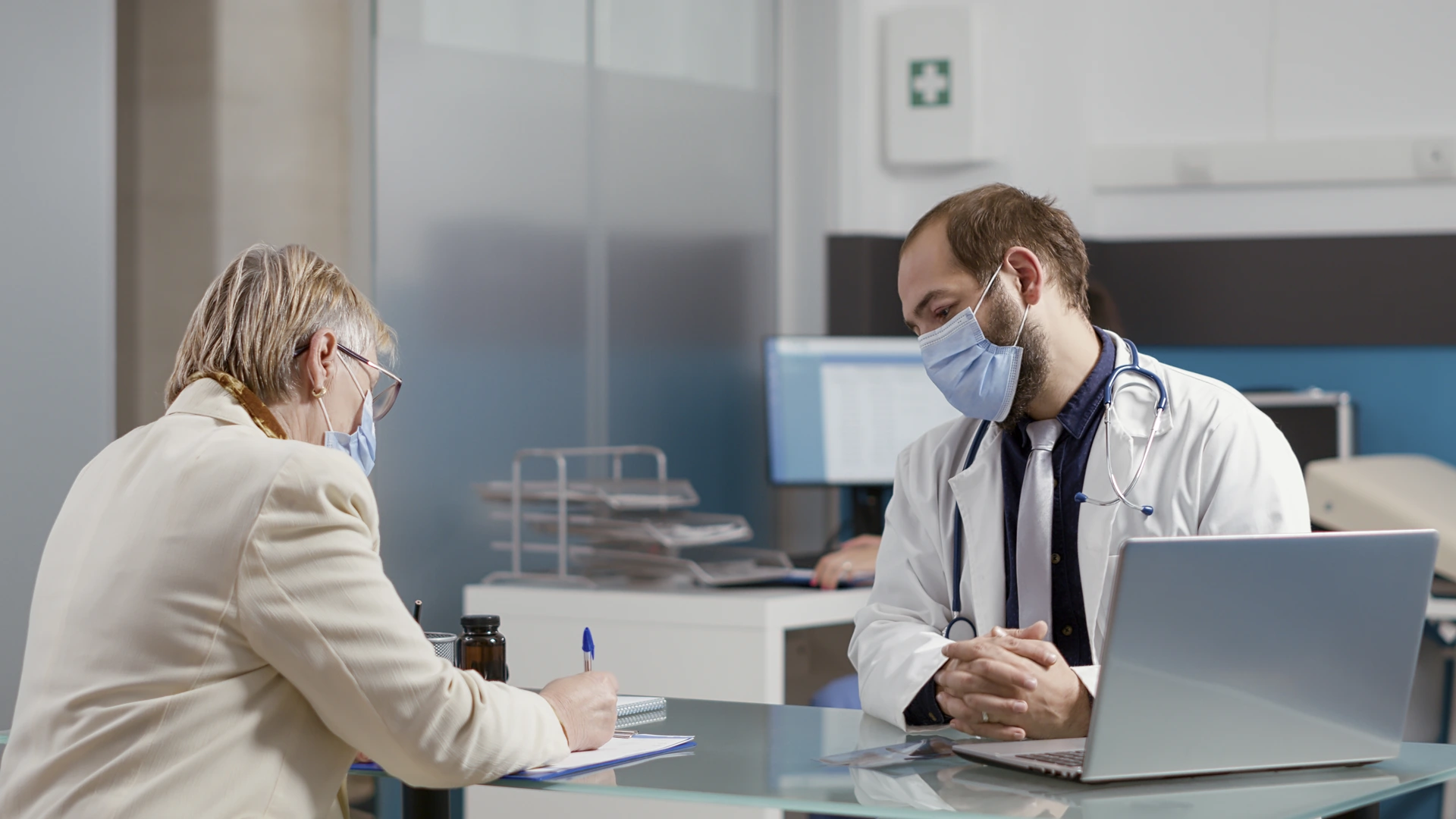Patient filling in her file during a consultation