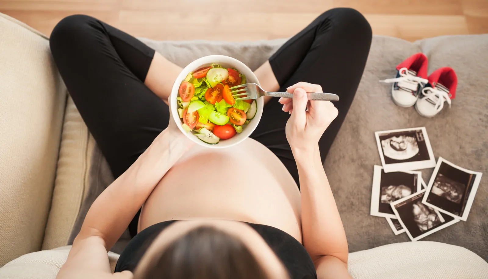 Pregnant woman with a balanced meal and her scans