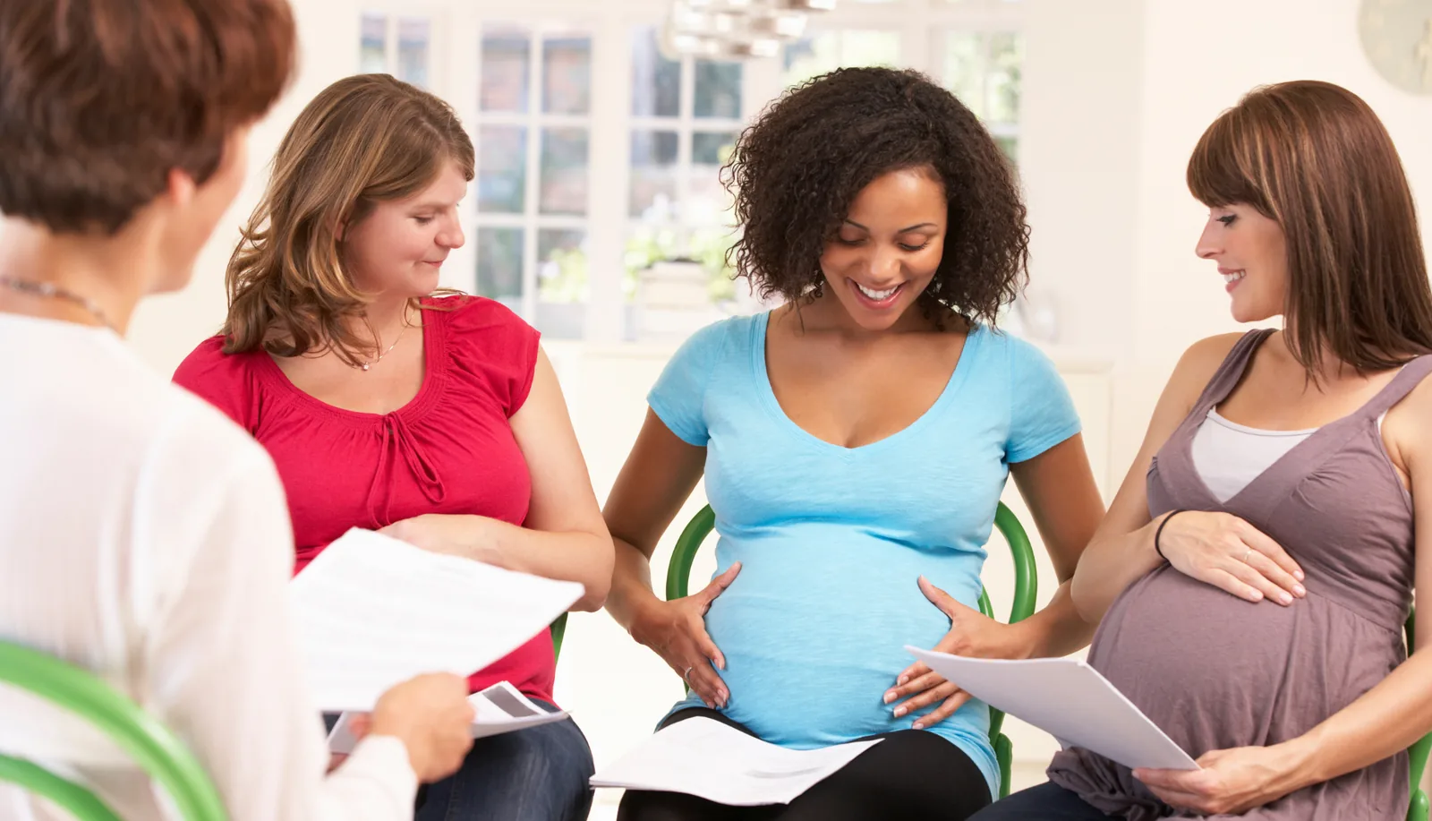 Pregnant women talking at a pregnancy information session